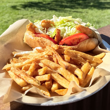 Hand Battered shrimp on a milano roll with zesty sauce and shredded lettuce