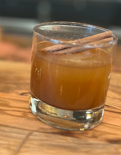 Stir. Garnished with cinnamon stick in lowball glass with whiskey ice cube